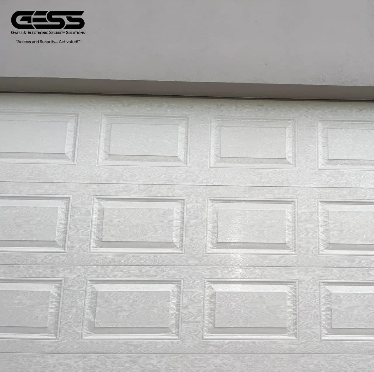White panelled sectional garage door seen close up