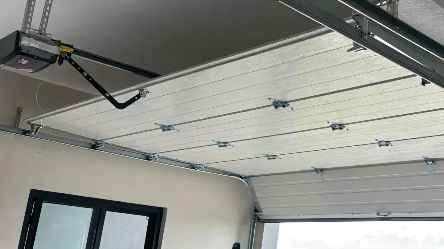 Garage door opener and rail mounted overhead