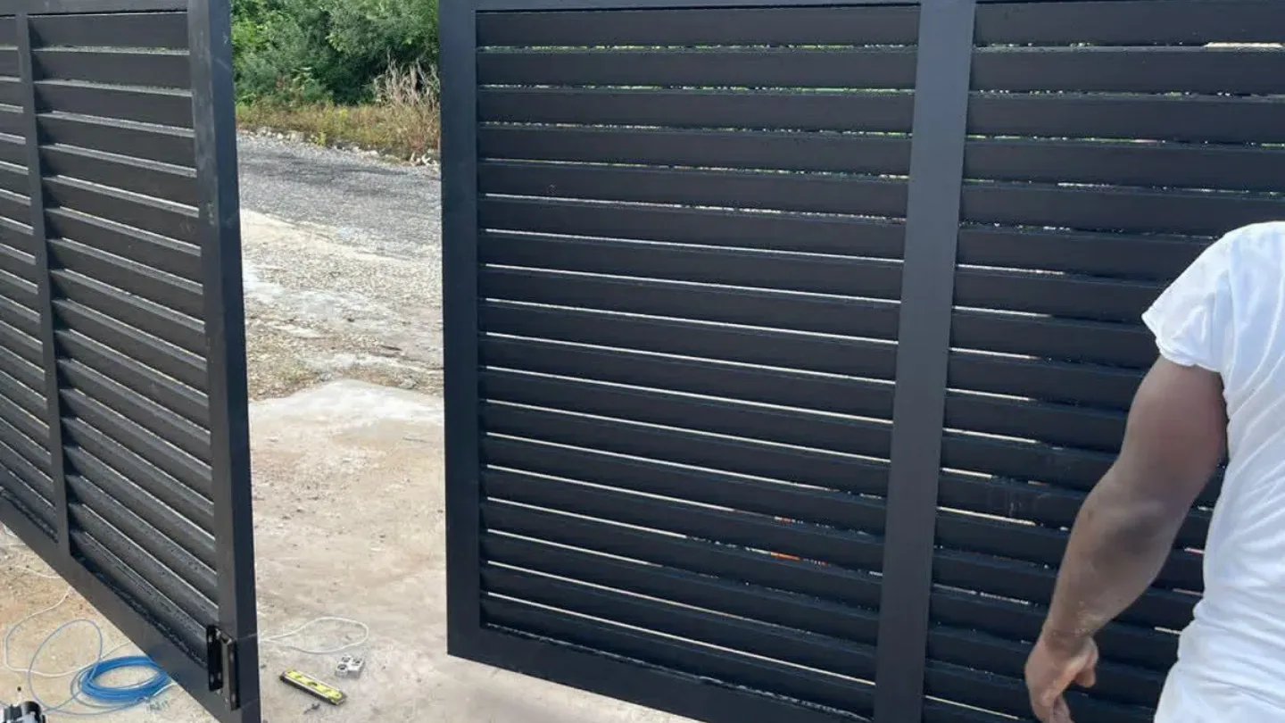 Sliding slat gate being set on site by a GESS technician